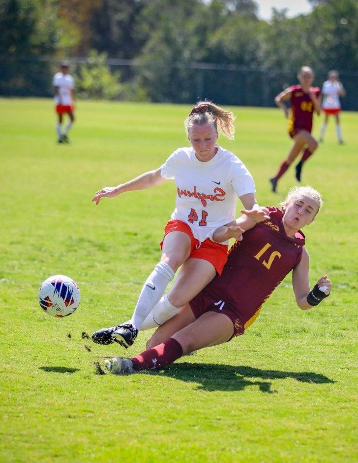 A student-athlete from the Pomona-Pitzer Sagehens steals the ball during a soccer match